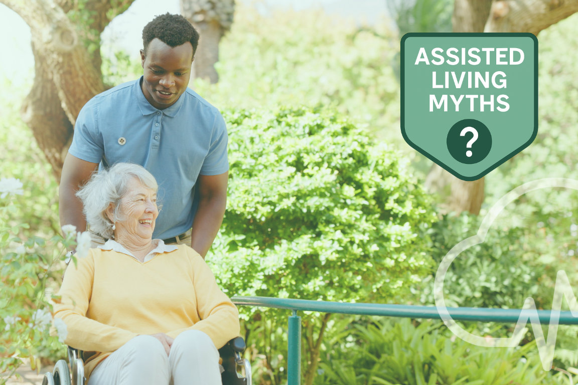 Caregiver assisting a smiling senior woman in a wheelchair outdoors, with a green badge that reads “Assisted Living Myths” and a question mark symbol.